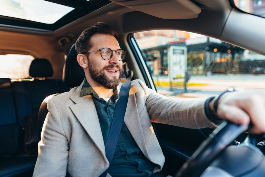New York driver wearing a seatbelt in a modern car